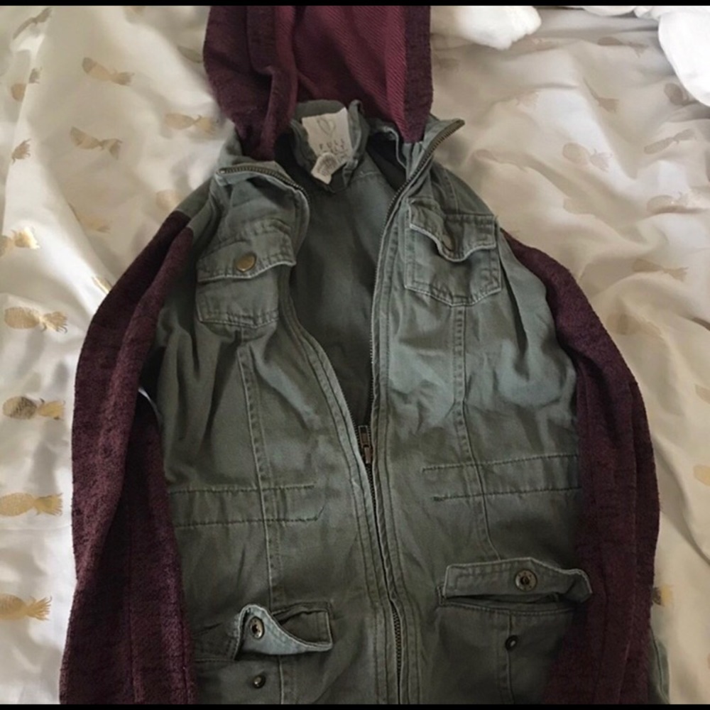 Green jacket with burgundy sleeves and hood.
